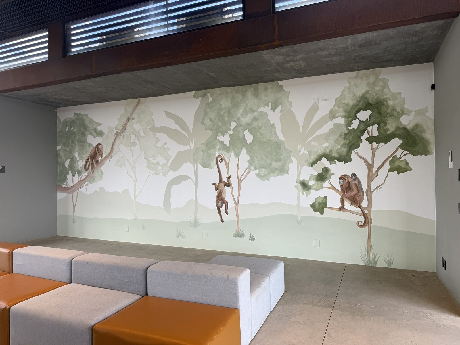 Mural de selva com bugios em espaço kids